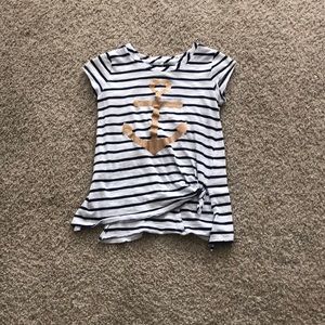 White shirt with blue stripes on it with an anchor